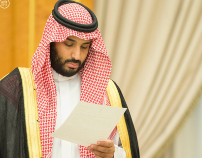 Saudi Arabia's Deputy Crown Prince Mohammed bin Salman looks at a document as Saudi Arabia's cabinet agrees to implement a broad reform plan known as Vision 2030 in Riyadh, April 25, 2016.