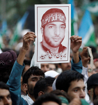 A picture of Hizbul Mujahideen commander Burhan Muzaffar Wani is held up during a rally condemning the violence in Kashmir, in Islamabad