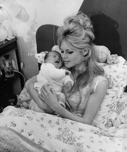 Brigitte Bardot holds her new son Nicolas in her Paris apartment January 13, 1960. The seven-pound boy born Jan.11, 1960 is her first. The French screen actress is married to actor Jacques Charrier. (AP Photo)