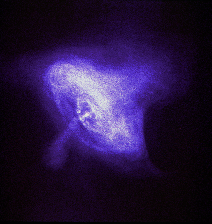 mage of the Crab Nebula seen in purples blues and white against a black backdrop taken by the Chandra X-Ray Observatory