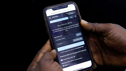 Abolaji Odunjo, a gadget vendor who trades with bitcoin, demonstrates a bitcoin application on his mobile phone in Lagos, Nigeria August 31, 2020.