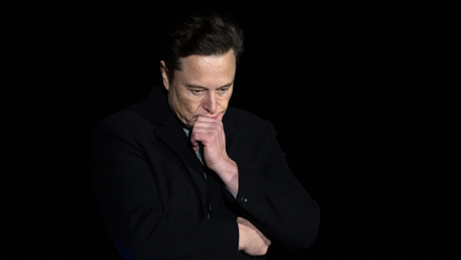Elon Musk looking pensive against a black backdrop