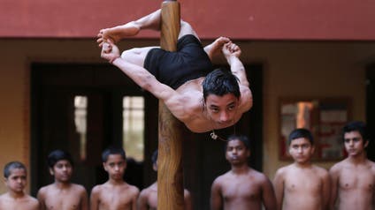 A participant practices "Mallakhamb" during a practice session for the upcoming competition to promote the sport, in Ahmedabad.