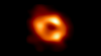 A blurry orange circle is shown in space with a dark black center.