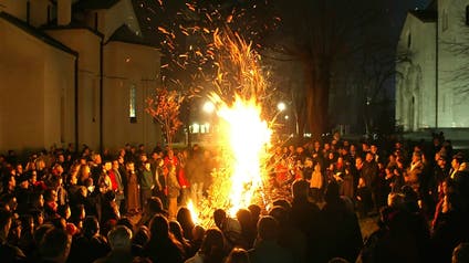 People watch a ceremonial burning of dried oak branches the Yule log symbol for the Orthodox Christmas Eve in front of St Sava church in central Belgrade. People watch a ceremonial burning of dried oak branches - the Yule log symbol for the Orthodox Christmas Eve in front of St. Sava church in central Belgrade January 6, 2005.