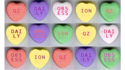 Conversation hearts candies with the word QZ DAILY OBSESS ION written on them.