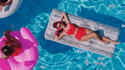 A woman listens to music on a pool float.