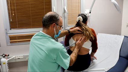 A person is being examined by a doctor in a clinic.