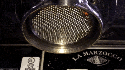 An animated gif of the underside of an espresso machine.