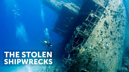 A very old-looking, barnacle-covered ship on its side at the bottom of the ocean with a diver swimming around it. The title reads The Stolen Shipwrecks