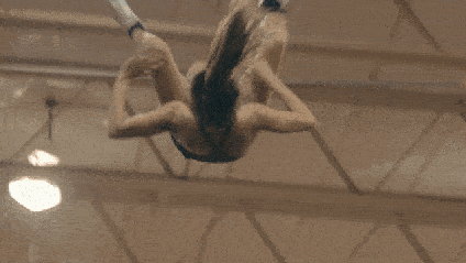 Navarro cheerleader Morgan Simianer twists midair in a cheer stunt.