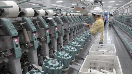 A worker is seen in Youngor&#039;s cotton spinning factory, in Aksu, Xinjiang Uighur Autonomous Region