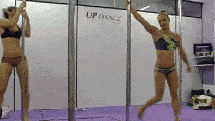 A woman performs pole-dancing tricks.