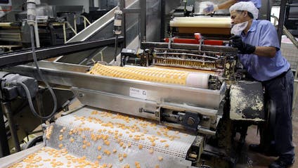 Candy hearts roll off a machine at Necco.