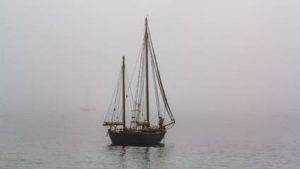 Tall ship sailing in the sea in foggy misty day