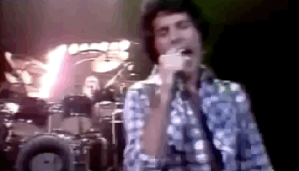 A gif of Freddie Mercury beckoning during Queen's "Bicycle Race" video.