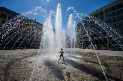 A child playing in a water fountain
