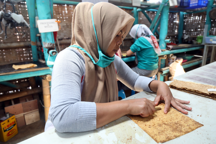 A worker prepares mycelium leather to be used for local products at Mycotech Eco Factory. 
