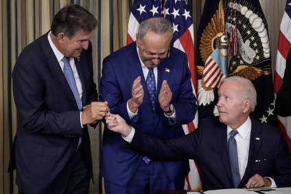 U.S. President Joe Biden (R) gives Sen. Joe Manchin (D-WV) (L) the pen he used to sign The Inflation Reduction Act with Senate Majority Leader Charles Schumer (D-NY) in the State Dining Room of the White House August 16, 2022 in Washington, DC.