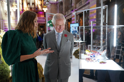 Prince Charles, Prince of Wales speaks to designer Stella McCartney who is explaining the process of making shoes from mycelium leather.