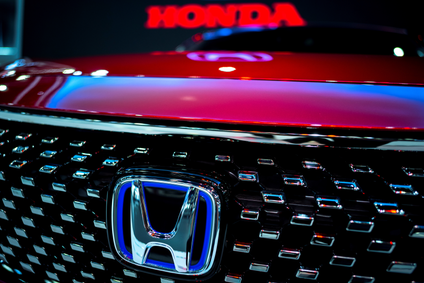 The Honda Motor logo is pictured on a red car.
