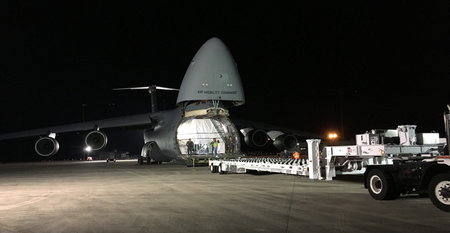 The special flatbed truck has to be lined up perfectly with the front cargo bay of the C-5.