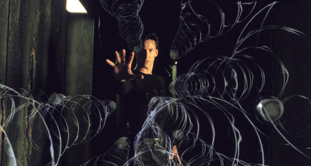 Keanu Reeves as Neo in The Matrix reaching out with magical spirals or something seemingly emanating from him.