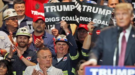 In this May 5, 2016 photo, Coal miners wave signs as Republican presidential candidate Donald Trump speaks during a rally in Charleston, W.Va. Trump&#039;s election could signal the end of many of President Barack Obama&#039;s signature environmental initiatives. Trump has said he loathes regulation and wants to use more coal and expand offshore drilling and hydraulic fracturing.