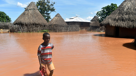 In this photo taken on Friday, April 27, 2018, a boy stands outside his family home, which has been submerged by floods following prolonged heavy rains in Tana Delta, Coastal Kenya. More than 30, 000 people in Tana River county have been displaced by floods which has also killed more than 5 people.