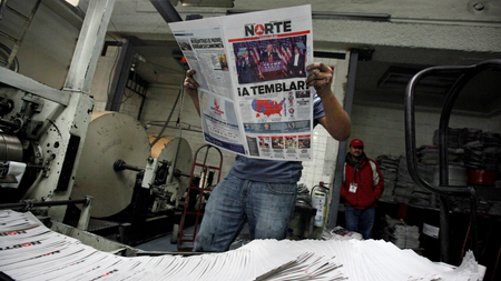 A worker reads a freshly printed newspaper with the headline reading &quot;We will tremble&quot; at a printer of the local daily Norte in Ciudad Juarez, Mexico, November 9, 2016.