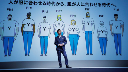 Yusaku Maezawa, the chief executive of Zozo, which operates Japan&#039;s popular fashion shopping site Zozotown and is officially called Start Today Co, speaks in front of a projection about Zozosuit at an event launching the debut of its formal apparel items, in Tokyo, Japan, July 3, 2018. Picture taken July 3, 2018. REUTERS/Kim Kyung-Hoon - RC1578C27420