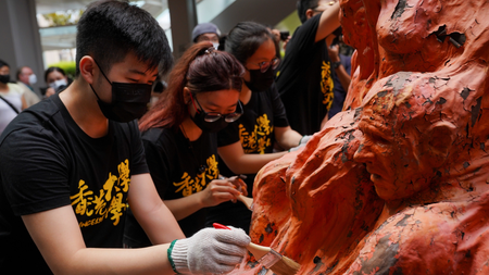 University students clean the &quot;Pillar of Shame&quot; statue at the University of Hong Kong on the 32nd anniversary of the crackdown on pro-democracy demonstrators at Beijing&#039;s Tiananmen Square in 1989, in Hong Kong, China June 4, 2021.