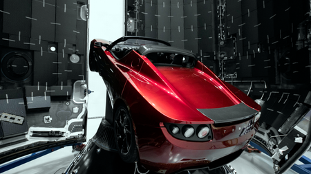 A Tesla roadster is tucked inside the carbon fiber fairing, or nose cone, on the Falcon Heavy rocket.