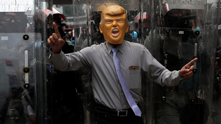 An anti-government protester wearing a mask depicting U.S. President Donald Trump demonstrates at Causeway Bay district in Hong Kong, China, September 29, 2019.