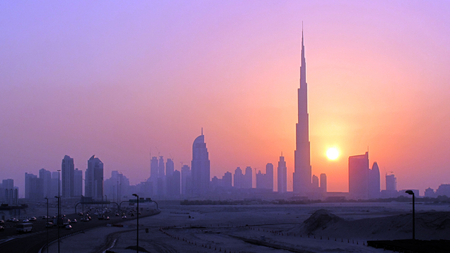 The Burj Khalifa (C) skyscrapper is seen as the sun sets over Dubai, October 5, 2010. REUTERS/Mosab Omar