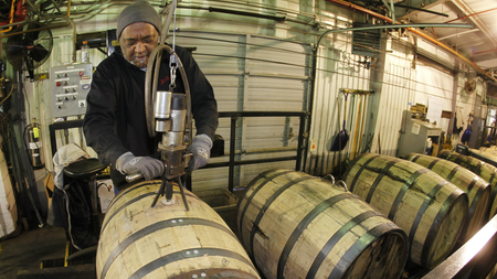 man with whiskey barrels