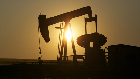 An oil pump jack pumps oil in a field near Calgary, Alberta, July 21, 2014.