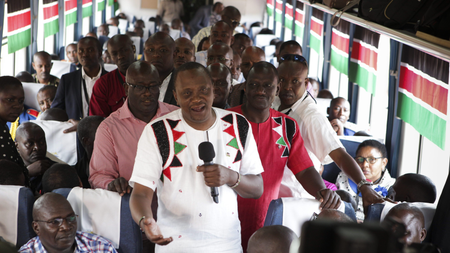 Kenyan president Uhuru Kenyatta, with his deputy president William Ruto, addresses a passenger train on the Standard Gauge Railway.