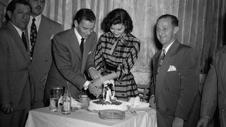 Frank Sinatra and his new bride, movie actress Ava Gardner, join hands as they cut a wedding cake in the Montmarte, a Havana, Cuba, nightclub November 8, 1951. Married November 7, in Philadelphia, they went to Havana on a whirlwind honeymoon.