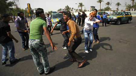 Iraqi teens dance in the street on the first day of Eid al-Fitr in Baghdad, Iraq, Sunday, Sept. 20, 2009.
