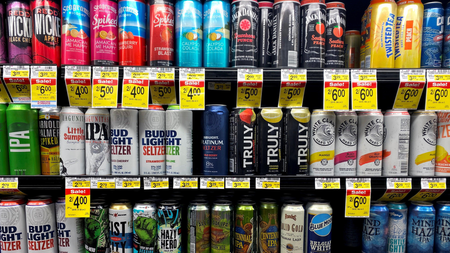 Supermarket shelf filled with seltzer drinks.