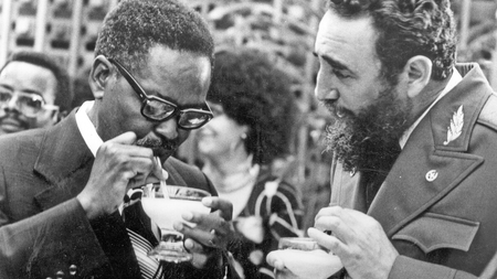 Cuban Prime Minister Fidel Castro, right, shows Angolan Movimento Popular de Liberta��o de Angola (MPLA) President Agostinho Neto how to drink a daikiri, a frozen Cuban drink made with rum, ice and sugar, during a reception in his honor in Havana, July 28, 1976.