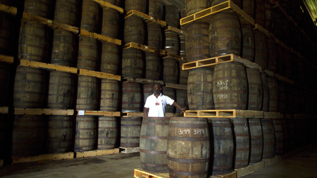 Jose Fundora, 55, looks to a colleague (not pictured) as he counts barrels of rum at a cellar of the Havana Club Distillery in San Jose de las Lajas, Cuba, May 12, 2015. Picture taken May 12, 2015.