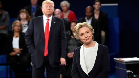 Democratic presidential nominee Hillary Clinton, right, and Republican presidential nominee Donald Trump listen to a question during the second presidential debate at Washington University in St. Louis, Sunday, Oct. 9, 2016.