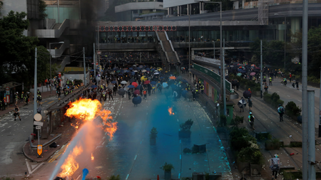 Riot police spray blue-coloured water during a protest on China&#039;s National Day in Hong Kong, China October 1, 2019.
