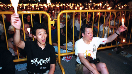 Han Dongfang (left) at a candle light vigil in Hong Kong on June 4, 1996 for the anniversary of the Tiananmen Massacre.