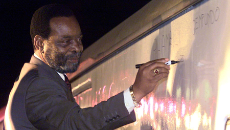 South Africa&#039;s Zulu King Goodwill Zwelithini signs a message on a train carriage in Zulu, &quot;Phambili Ngemfundo&quot; or &quot;forward with education&quot; at Durban station in 2000.