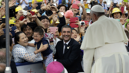 A child cries as his mother holds him up to Pope Francis in Seoul, Korea.