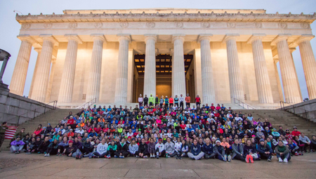 An image of a group of runners sitting on the Lincoln Memorial steps.