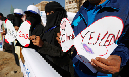 Yemeni protesters hold placards